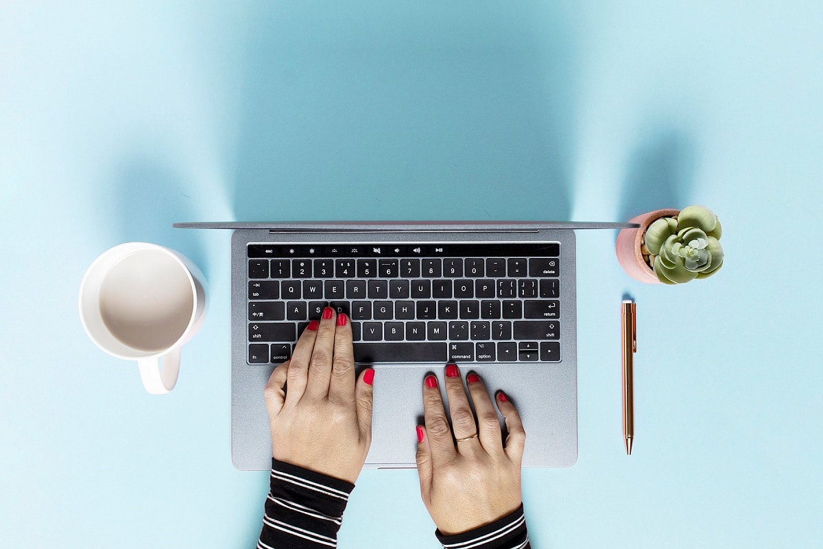 Woman's hands on a laptop keyboard as she sets up her site with Google Search Console