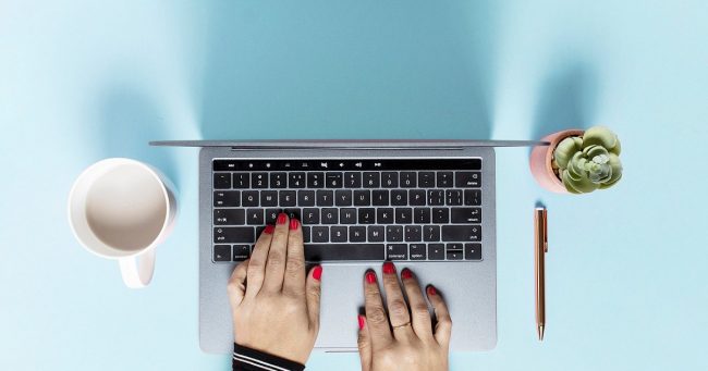 Woman's hands on a laptop keyboard as she sets up her site with Google Search Console